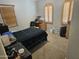 Bedroom with carpet, blue blanket, and two windows with wooden shutters and blinds at 36119 W Catalan St, Maricopa, AZ 85138