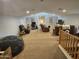 Expansive bonus room with versatile seating, neutral carpet, and bright natural lighting, ideal for recreation or relaxation at 36119 W Catalan St, Maricopa, AZ 85138