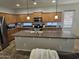 Well-equipped kitchen with stainless steel appliances, ample countertop space, and a functional center island at 36119 W Catalan St, Maricopa, AZ 85138