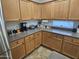 Spacious kitchen featuring light wood cabinets, stainless steel appliances, and granite countertops at 36119 W Catalan St, Maricopa, AZ 85138