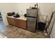 Functional laundry area with ample counter space, storage cabinets, and a convenient mini-fridge for added utility at 36119 W Catalan St, Maricopa, AZ 85138