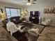 Comfortable living room featuring two sofas, entertainment center and large windows that fill the room with natural light at 36119 W Catalan St, Maricopa, AZ 85138