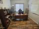 Office with a large desk, wood-look floors, and a bright window at 36119 W Catalan St, Maricopa, AZ 85138