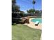 Backyard view featuring a private pool with diving board, patio, and manicured lawn at 3811 E Evans Dr, Phoenix, AZ 85032