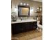 Bathroom vanity with black cabinets and decorative tile trim on the floor at 3811 E Evans Dr, Phoenix, AZ 85032