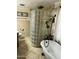 Bright bathroom showcasing a glass block shower, a freestanding bathtub, and neutral toned tiling at 3811 E Evans Dr, Phoenix, AZ 85032
