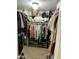Walk-in closet with shelving units and hanging racks filled with clothes and accessories at 3811 E Evans Dr, Phoenix, AZ 85032
