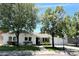 Charming single-story home with a well-manicured lawn, mature trees, and a welcoming front entrance at 3811 E Evans Dr, Phoenix, AZ 85032