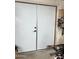 Garage doors with white panels and metal frames leading to the interior of the garage/workshop space at 3811 E Evans Dr, Phoenix, AZ 85032