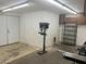 Spacious garage interior featuring a drill press, shelving, and access door to the main house at 3811 E Evans Dr, Phoenix, AZ 85032