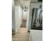 A bright hallway leads past a modern stainless steel refrigerator and cabinets at 3811 E Evans Dr, Phoenix, AZ 85032