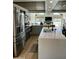 Bright, open kitchen with stainless steel appliances and a large island at 3811 E Evans Dr, Phoenix, AZ 85032