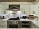 Gourmet kitchen featuring stainless steel appliances, modern backsplash, and ample counter space at 3811 E Evans Dr, Phoenix, AZ 85032