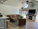 Cozy living room with sectional seating, high ceilings, and natural light from large windows at 3811 E Evans Dr, Phoenix, AZ 85032