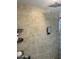 Modern shower featuring tan tiled walls, shelving, and a rain-style shower head at 3811 E Evans Dr, Phoenix, AZ 85032