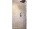 Walk-in shower featuring a glass block wall, neutral tiles, and a rainfall shower head at 3811 E Evans Dr, Phoenix, AZ 85032