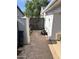 Practical side yard with stone pavers, gate, and storage shed offers functionality at 3811 E Evans Dr, Phoenix, AZ 85032