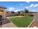 Spacious backyard showcasing a well-maintained lawn, brick pathway, and desert landscaping at 3936 E Narrowleaf Dr, Gilbert, AZ 85298
