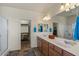 Bright primary bathroom featuring double sinks, a walk-in shower, and closet with storage at 3936 E Narrowleaf Dr, Gilbert, AZ 85298