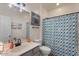 Bathroom with a colorful shower curtain, vanity, sink, and framed decorations at 3936 E Narrowleaf Dr, Gilbert, AZ 85298