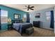 Bedroom with natural light, carpeted floor, ceiling fan, and light blue wall color at 3936 E Narrowleaf Dr, Gilbert, AZ 85298