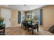 Bright dining area with dark wood furniture and neutral colored tile flooring at 3936 E Narrowleaf Dr, Gilbert, AZ 85298