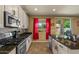 Modern kitchen with a center island, stainless steel appliances, and a tile backsplash at 3936 E Narrowleaf Dr, Gilbert, AZ 85298