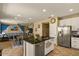 Beautiful kitchen island with stainless steel appliances and an open view to the dining room and living room at 3936 E Narrowleaf Dr, Gilbert, AZ 85298