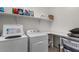 Functional laundry room with washer, dryer, ample shelving, and storage space at 3936 E Narrowleaf Dr, Gilbert, AZ 85298