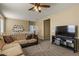 Relaxing living room featuring a large TV and a cozy sectional sofa at 3936 E Narrowleaf Dr, Gilbert, AZ 85298