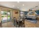 Open-concept living room and dining area with large windows and sliding glass doors to the backyard at 3936 E Narrowleaf Dr, Gilbert, AZ 85298