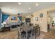 Open concept living and dining area with a ceiling fan, TV, stylish decorations and comfortable seating at 3936 E Narrowleaf Dr, Gilbert, AZ 85298