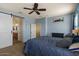Large main bedroom featuring a ceiling fan, barn door to bathroom and dresser at 3936 E Narrowleaf Dr, Gilbert, AZ 85298