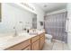 Bathroom featuring double sinks, a large mirror, and a shower with patterned gray curtain at 5263 E Hannibal St, Mesa, AZ 85205