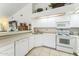 Clean kitchen with all-white cabinetry and appliances at 5263 E Hannibal St, Mesa, AZ 85205