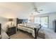 Comfortable main bedroom with a ceiling fan and a sliding glass door at 5263 E Hannibal St, Mesa, AZ 85205