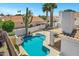 Aerial view showcasing a sparkling pool, covered patio, desert landscaping, and spiral staircase at 5345 E Mclellan Rd # 123, Mesa, AZ 85205