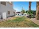 Expansive lawn and desert landscaping in the backyard with a view of the house at 5345 E Mclellan Rd # 123, Mesa, AZ 85205