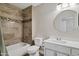 Bathroom featuring a tub with decorative tile surround and a vanity with a round mirror at 5345 E Mclellan Rd # 123, Mesa, AZ 85205