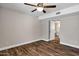 Bedroom features wood floors, a ceiling fan, and doorway to the bathroom at 5345 E Mclellan Rd # 123, Mesa, AZ 85205