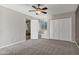 Spacious bedroom featuring neutral carpeting, a ceiling fan, and double door closet at 5345 E Mclellan Rd # 123, Mesa, AZ 85205