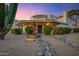 Beautiful desert home featuring a front fountain and lush, mature landscaping at 5345 E Mclellan Rd # 123, Mesa, AZ 85205