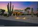 Inviting desert home with lush landscaping, fountain, and walkway at twilight at 5345 E Mclellan Rd # 123, Mesa, AZ 85205