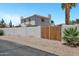 Charming home featuring a white stucco wall and gate complemented by lush landscaping and a clear blue sky at 5345 E Mclellan Rd # 123, Mesa, AZ 85205