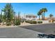 Desert home showcasing mature cacti, palm trees, and lush green bushes along a quiet street at 5345 E Mclellan Rd # 123, Mesa, AZ 85205