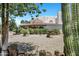 Desert home showcasing well-maintained front yard landscaping with mature cacti, shrubs, and a charming fountain at 5345 E Mclellan Rd # 123, Mesa, AZ 85205