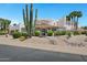 Charming home with lush desert landscaping and a decorative water fountain, showcasing curb appeal at 5345 E Mclellan Rd # 123, Mesa, AZ 85205