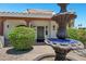 Close-up of home featuring a water fountain, trimmed greenery, and covered entryway with desert landscaping at 5345 E Mclellan Rd # 123, Mesa, AZ 85205