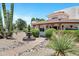 Close-up of a desert-landscaped home featuring a decorative water fountain and manicured greenery at 5345 E Mclellan Rd # 123, Mesa, AZ 85205