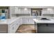 Bright kitchen featuring white cabinets, marble countertops, and an island with a cooktop at 5345 E Mclellan Rd # 123, Mesa, AZ 85205